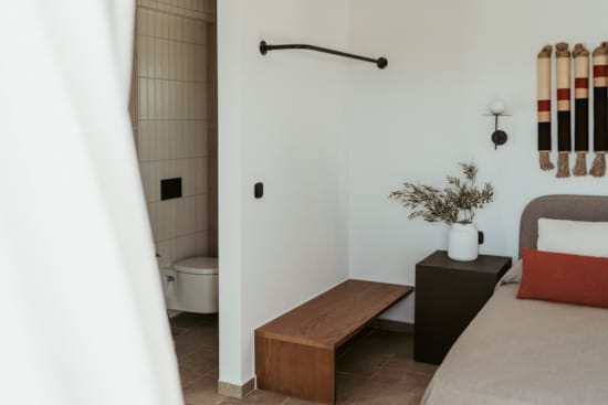 a small bathroom with a bed and a bench