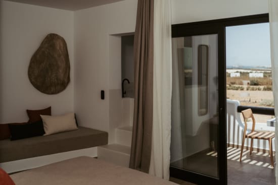 a bedroom with a large glass door
