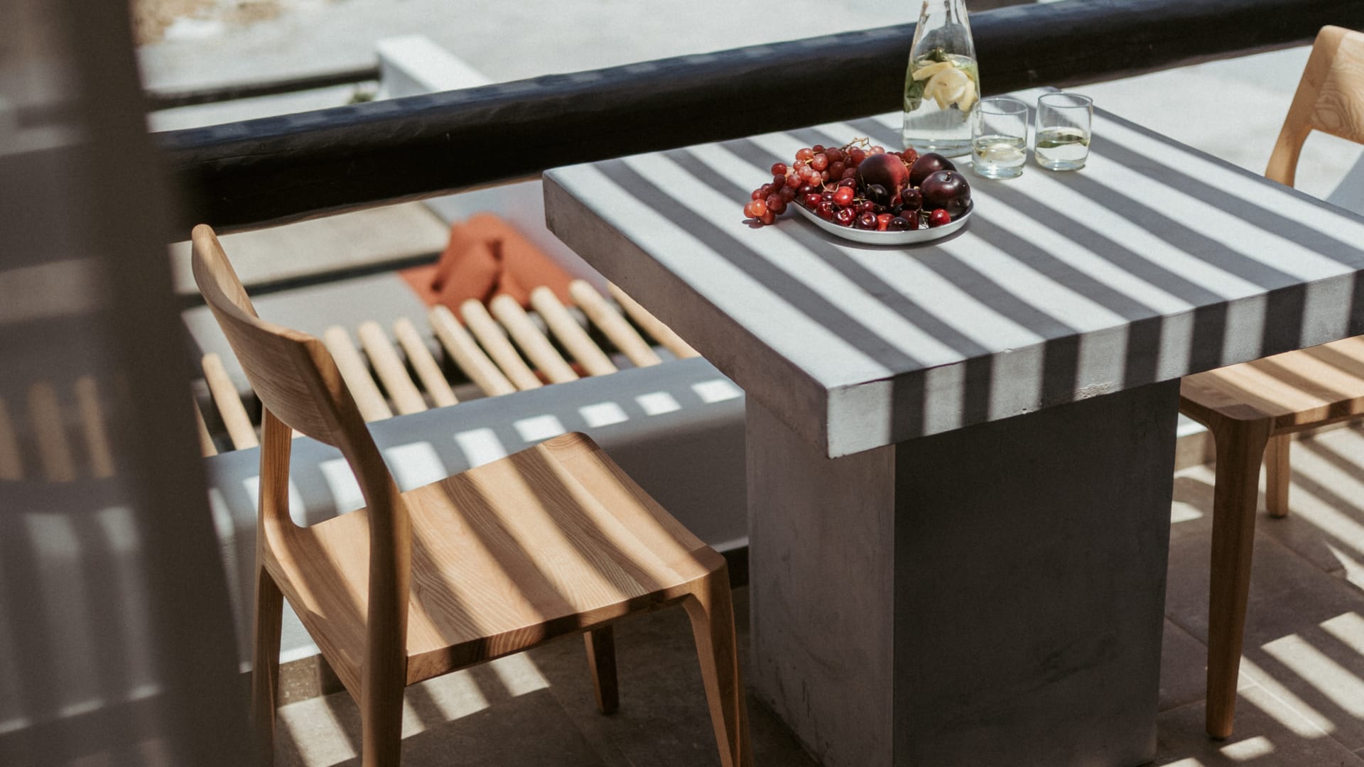 a table with a plate of food on it and a view of a city and a valley
