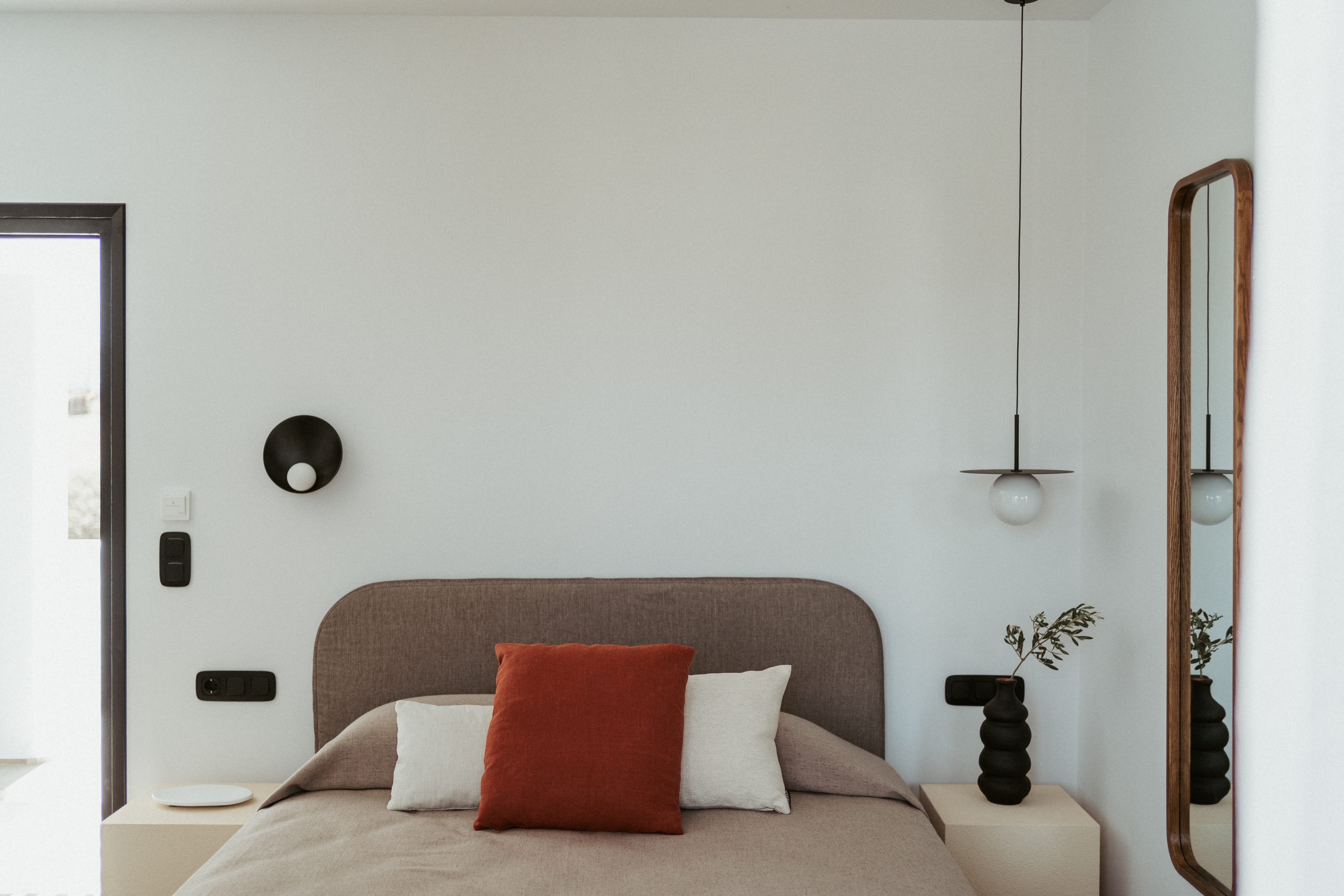 a bed with a red pillow