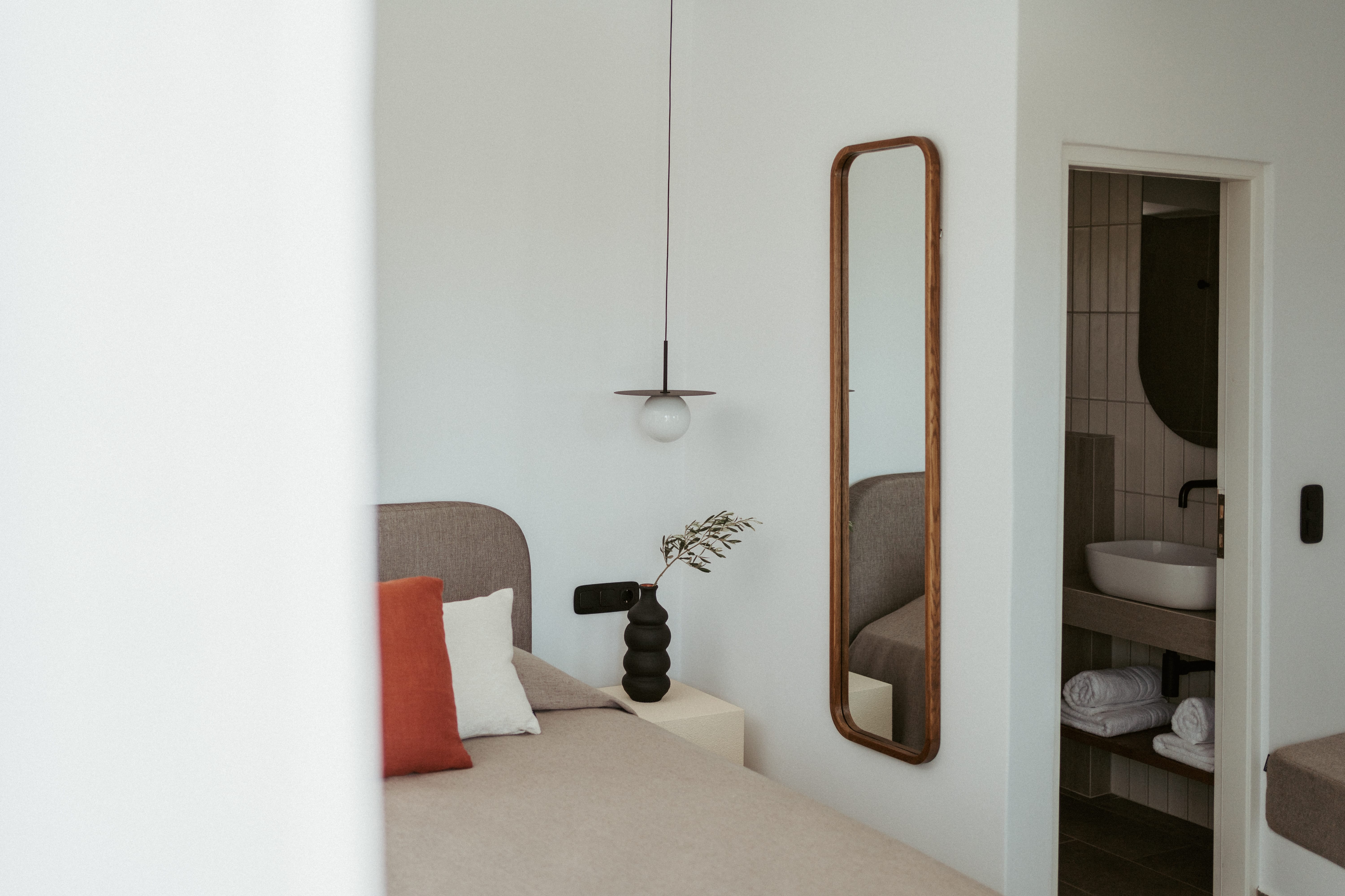a bathroom with a mirror and a bed