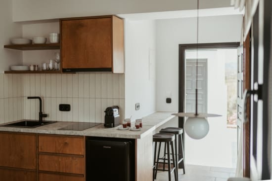 a kitchen with a stool and a window