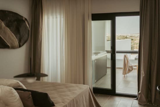 a bedroom with a large glass door
