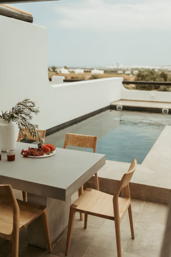 a table and chairs by a pool
