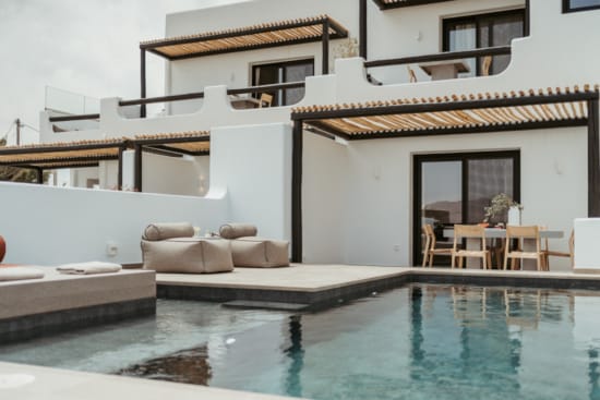 a pool with a house in the background