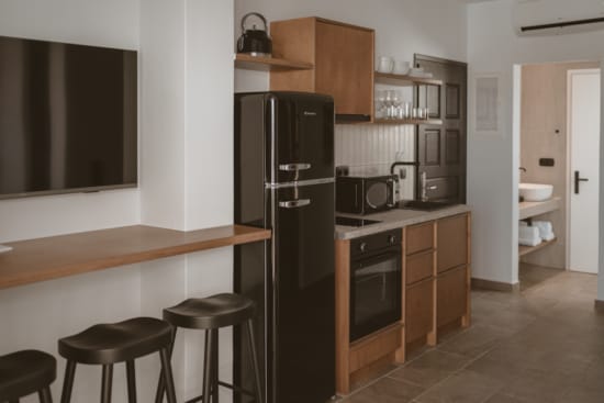 a kitchen with stools and a bar