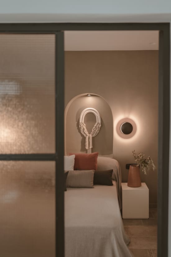 a bedroom with a bed and a mirror