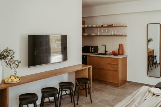 a room with a tv and stools
