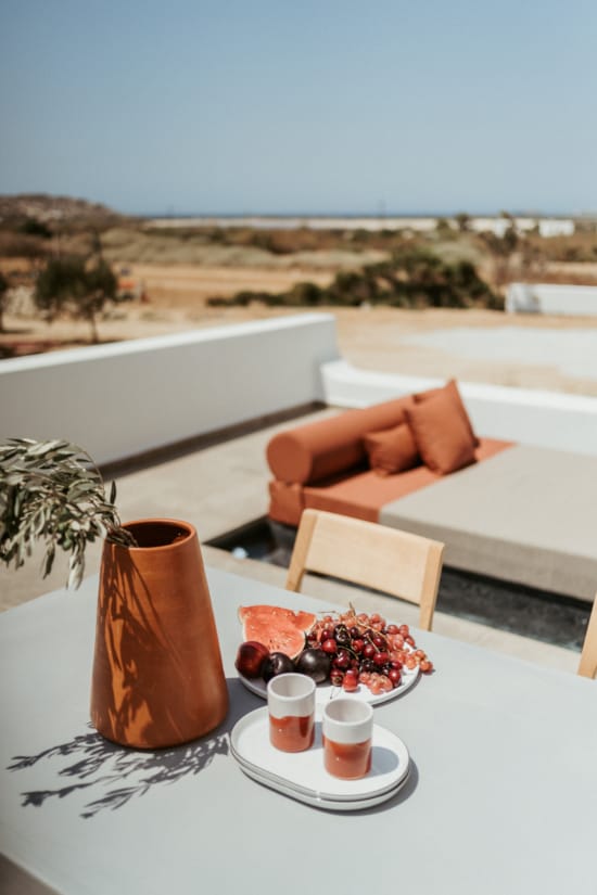 a table with a plate of food and a vase of flowers