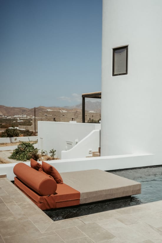 a couch and a table by the water