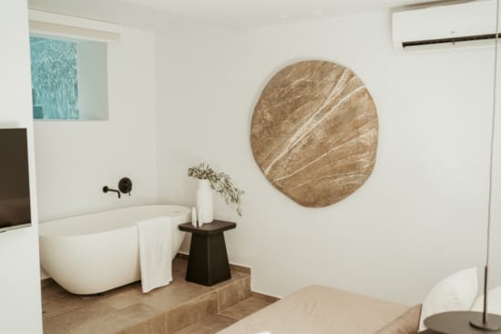 a bathroom with a large round mirror