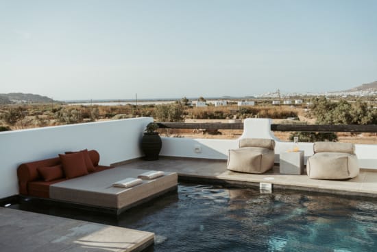 a pool with a couch and pillows