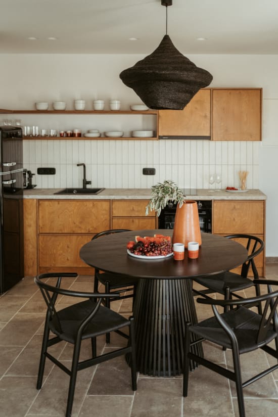 a kitchen with a table and chairs