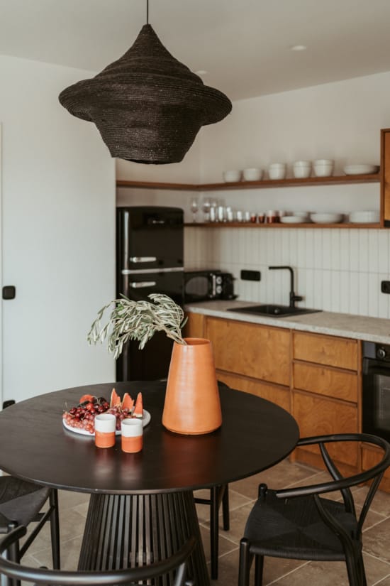 a kitchen with a table and chairs