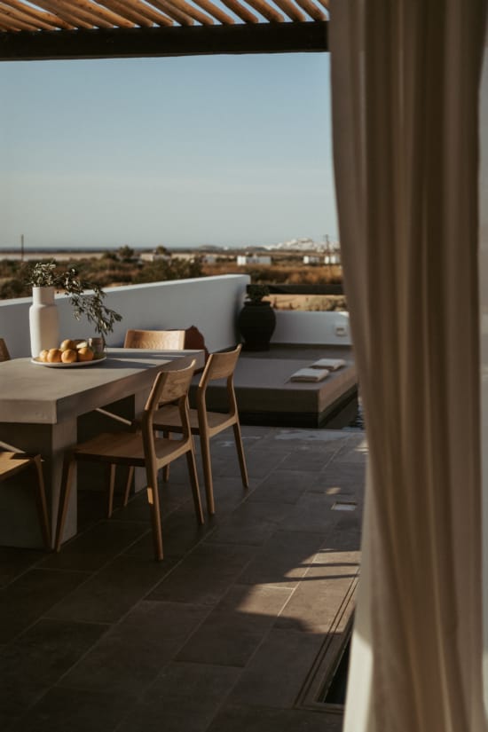 a table and chairs on a balcony