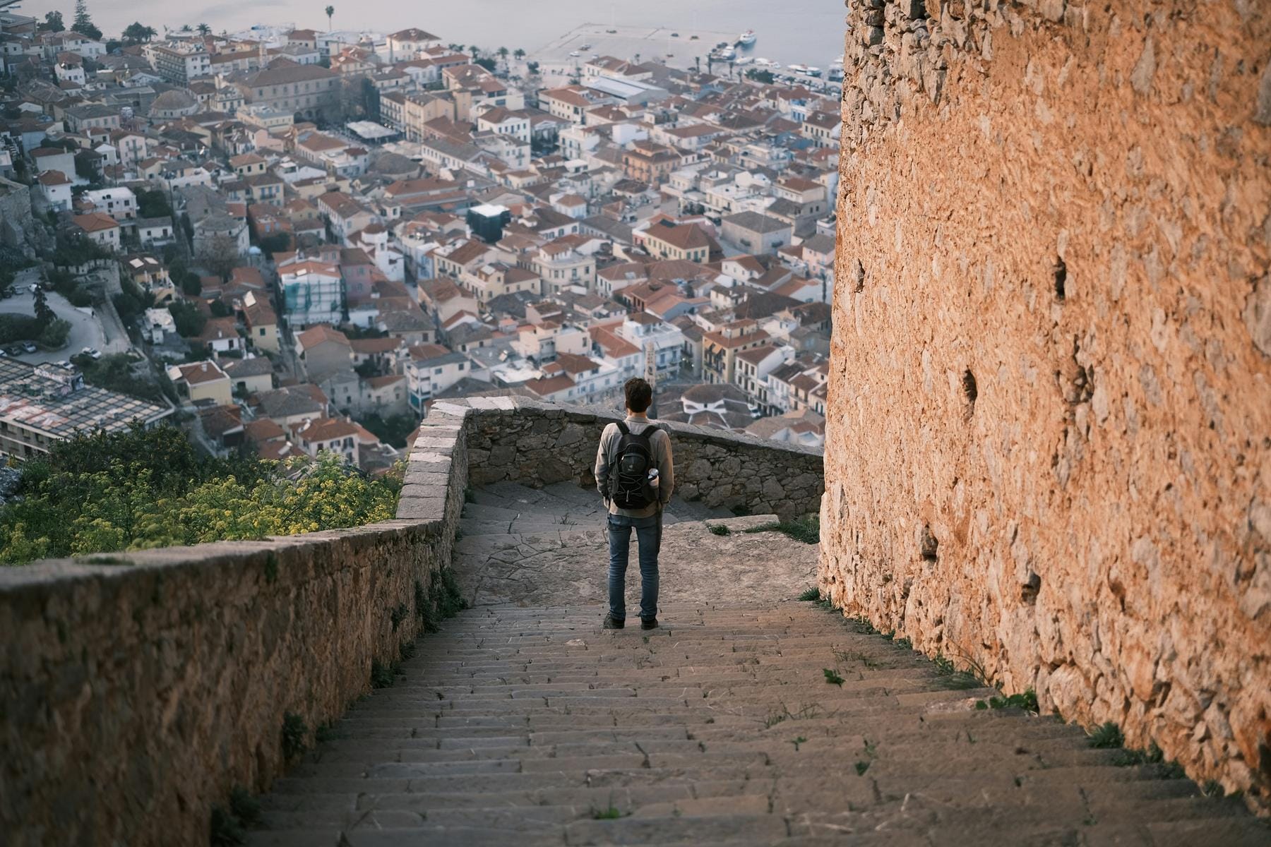 a person standing on a stone bridge