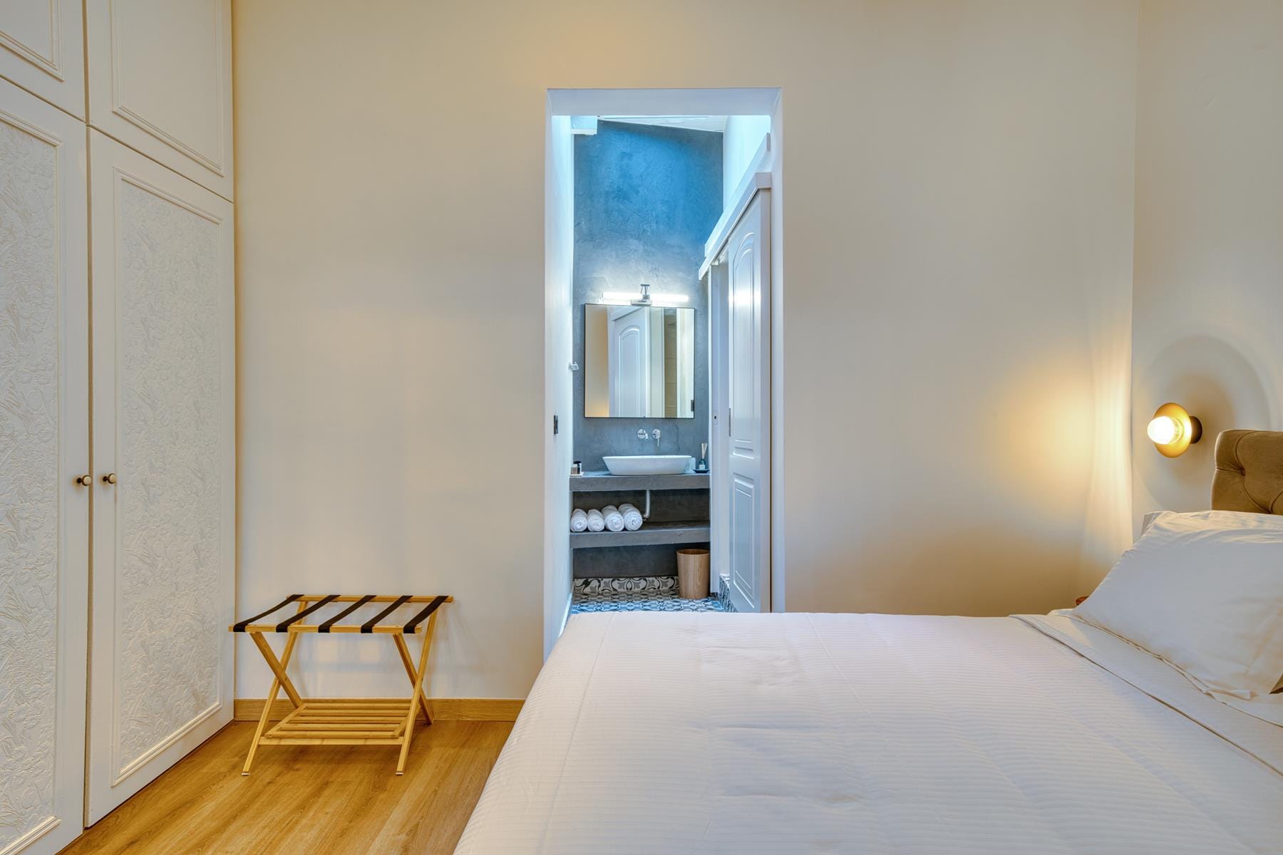 a bedroom with a bed and a mirror