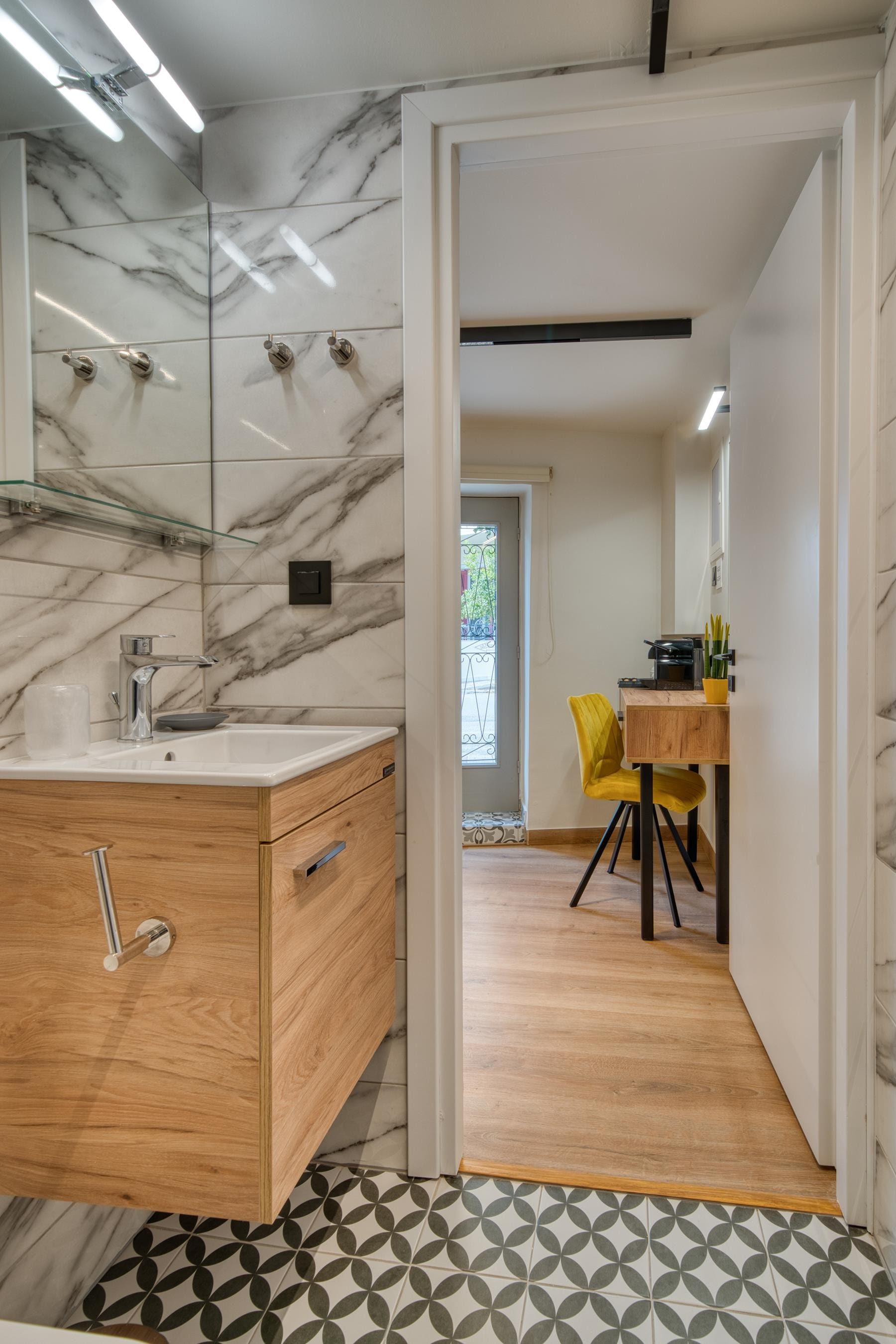 a bathroom with a sink and a chair