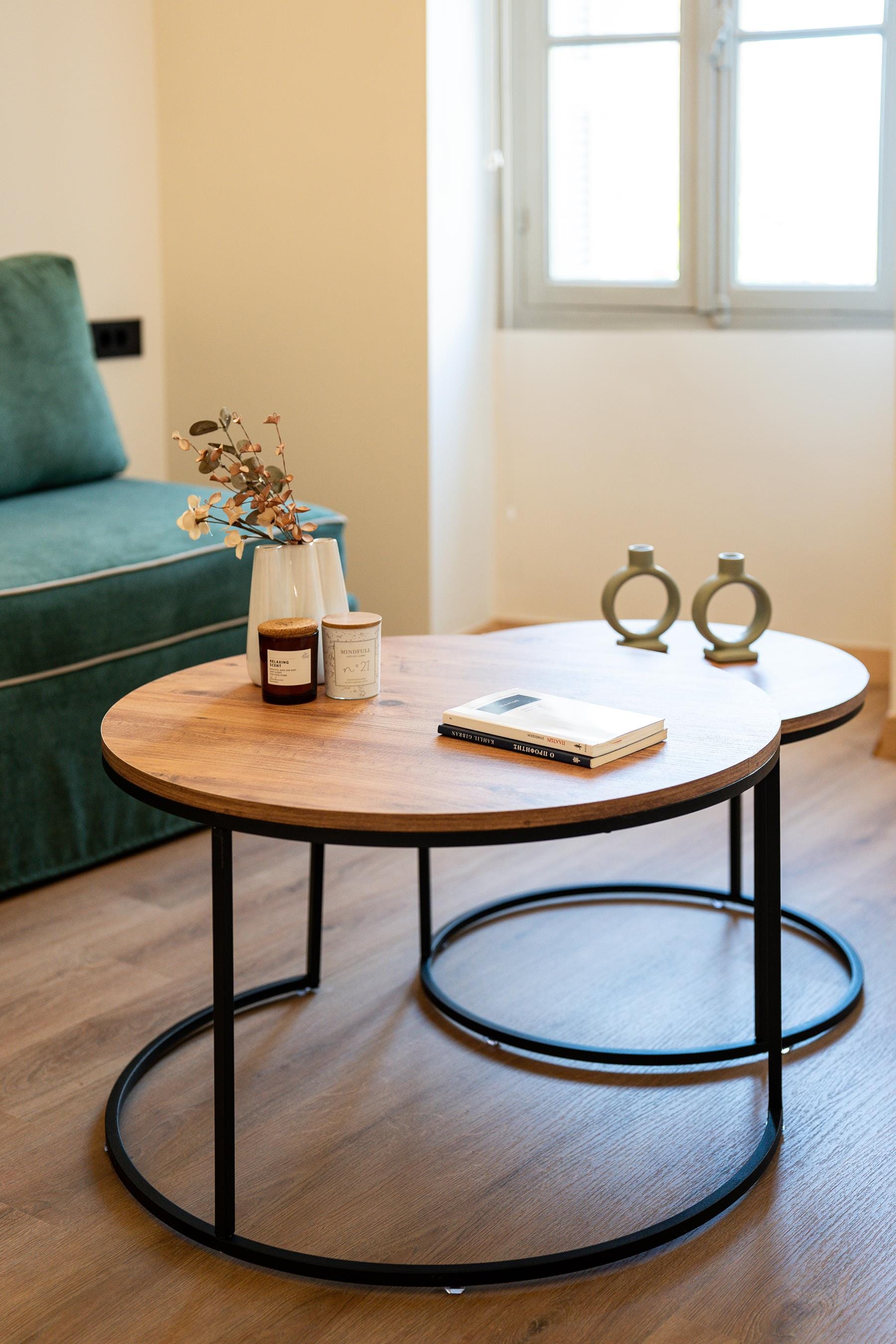 a table with a vase and candles on it