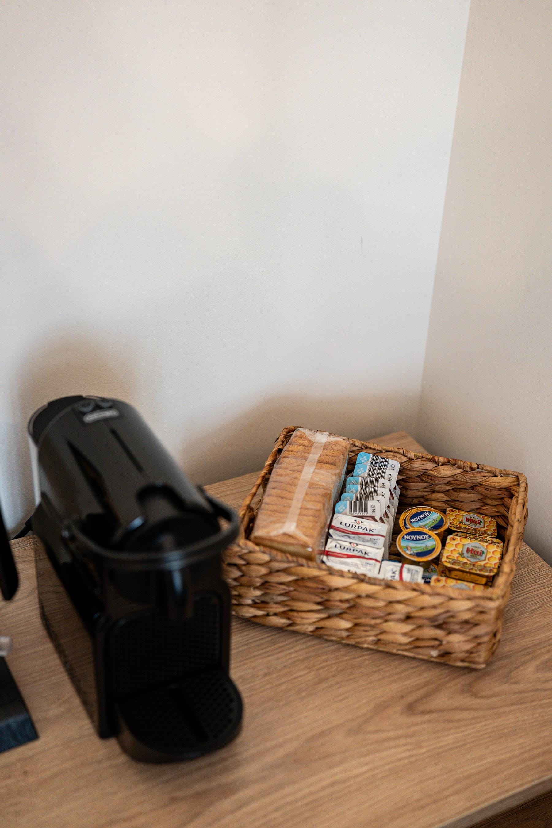 a basket of chips and a vacuum cleaner on a wood floor