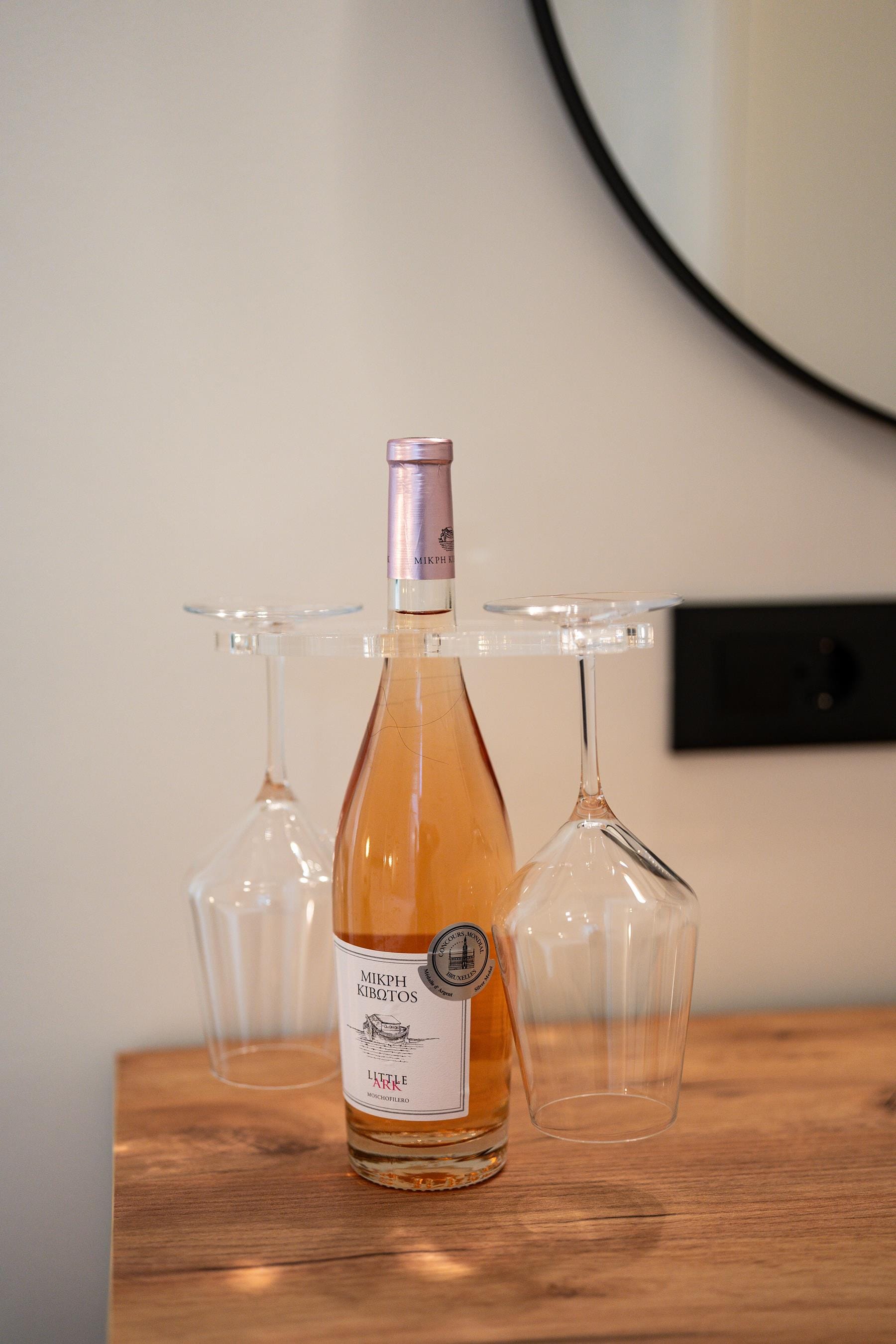 a bottle of alcohol and a glass of water on a table