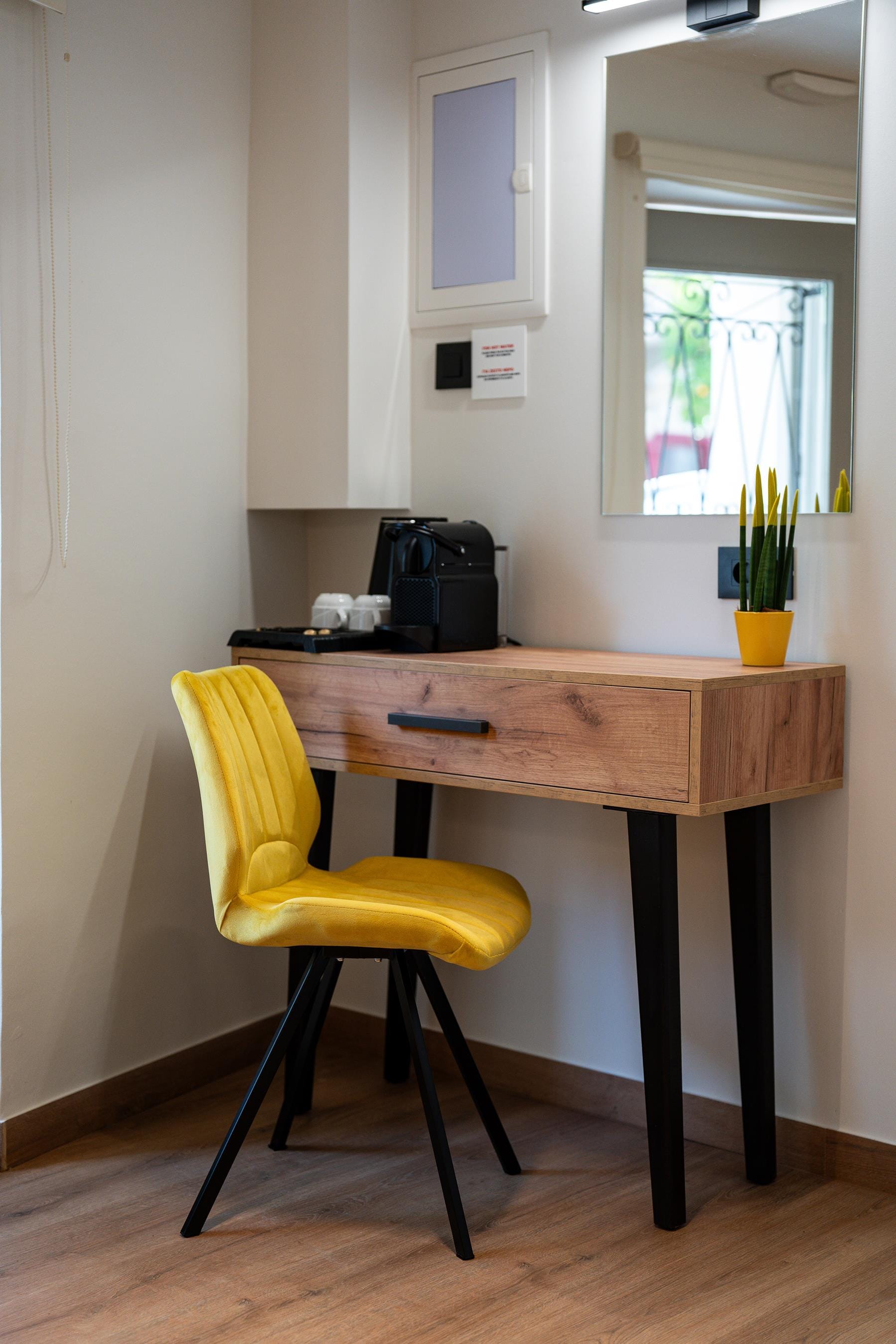 a desk with a chair and a window