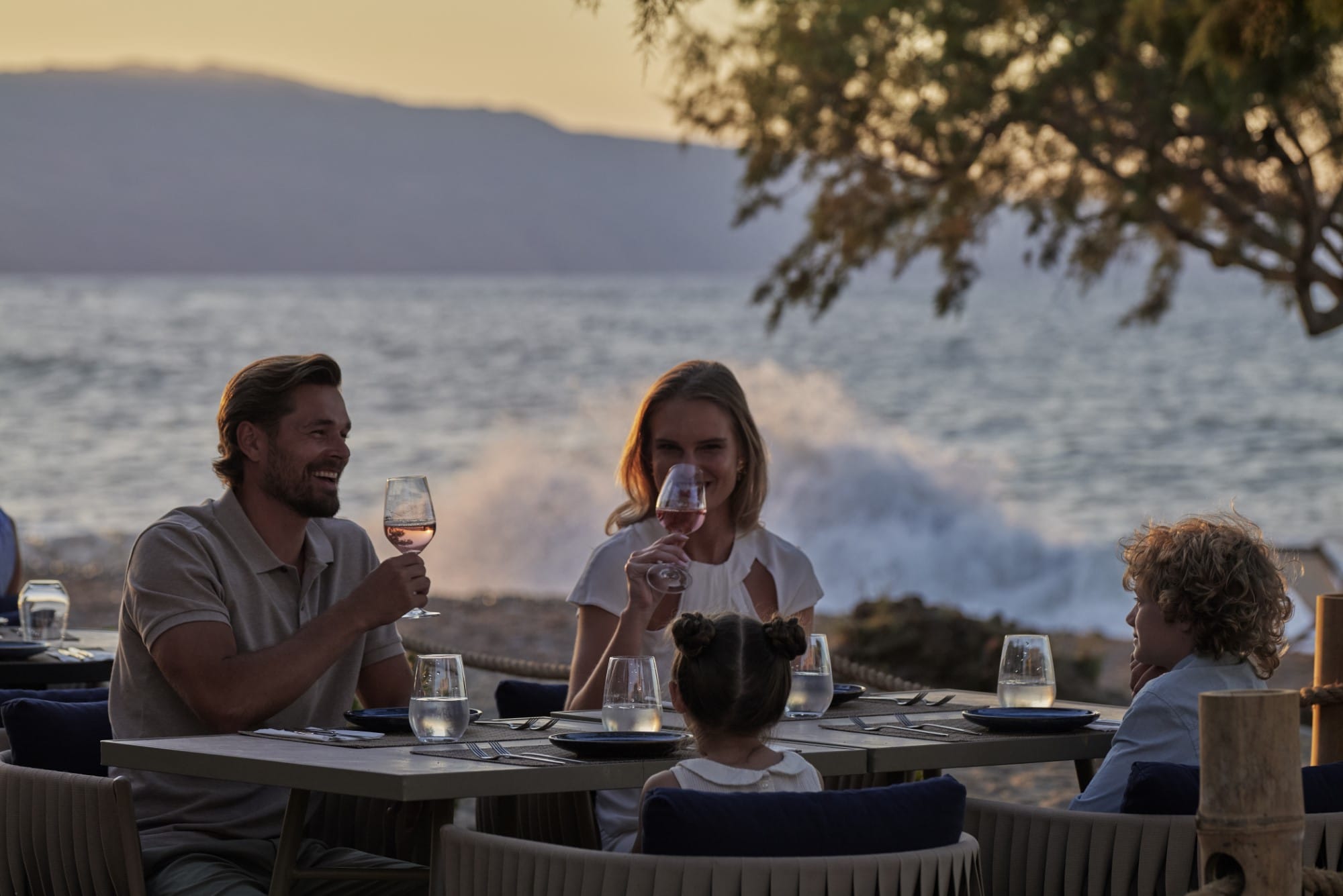 Family eating at a seaside restaurant at Atlatnica Hotels