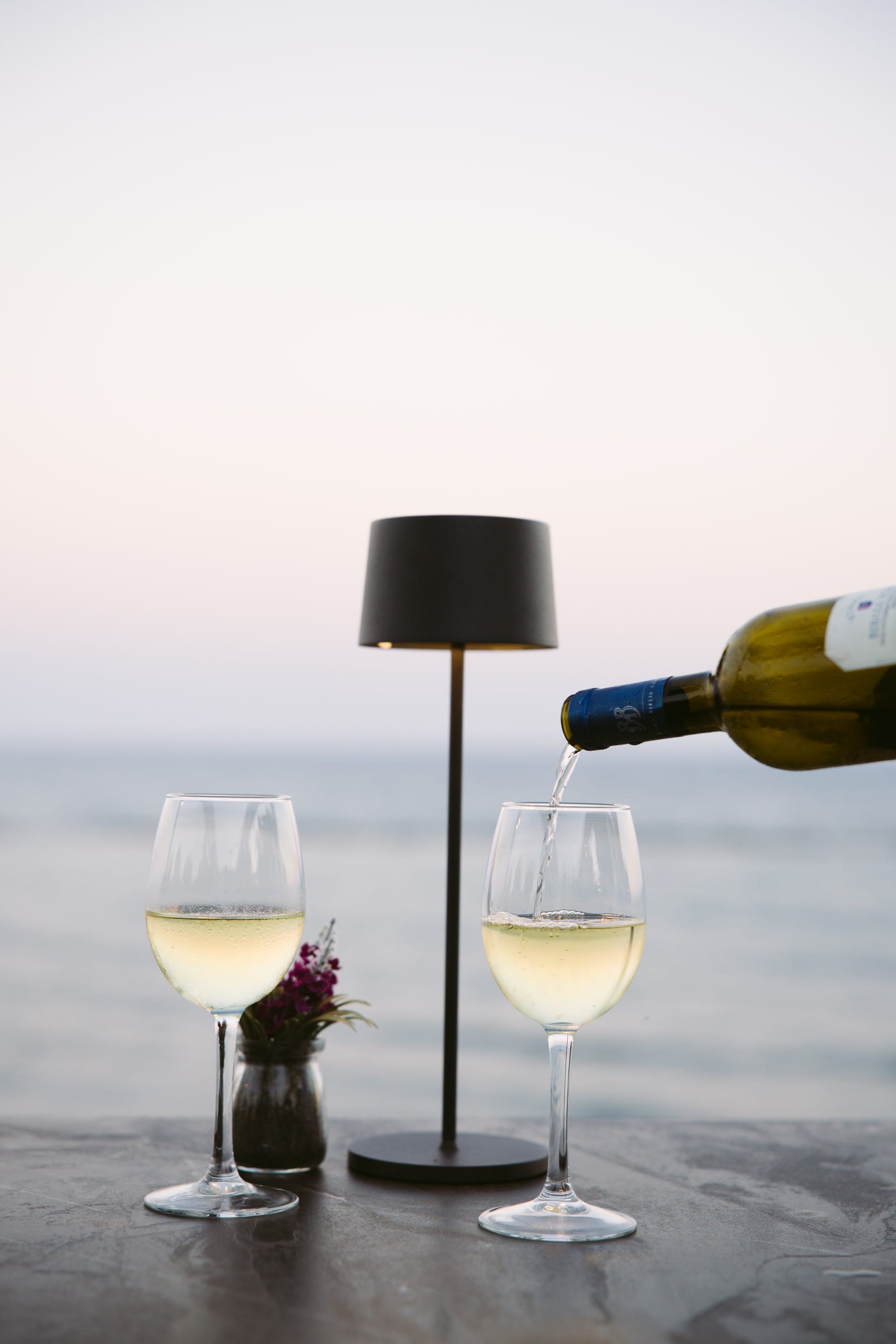 a bottle of wine and glasses of wine on a table