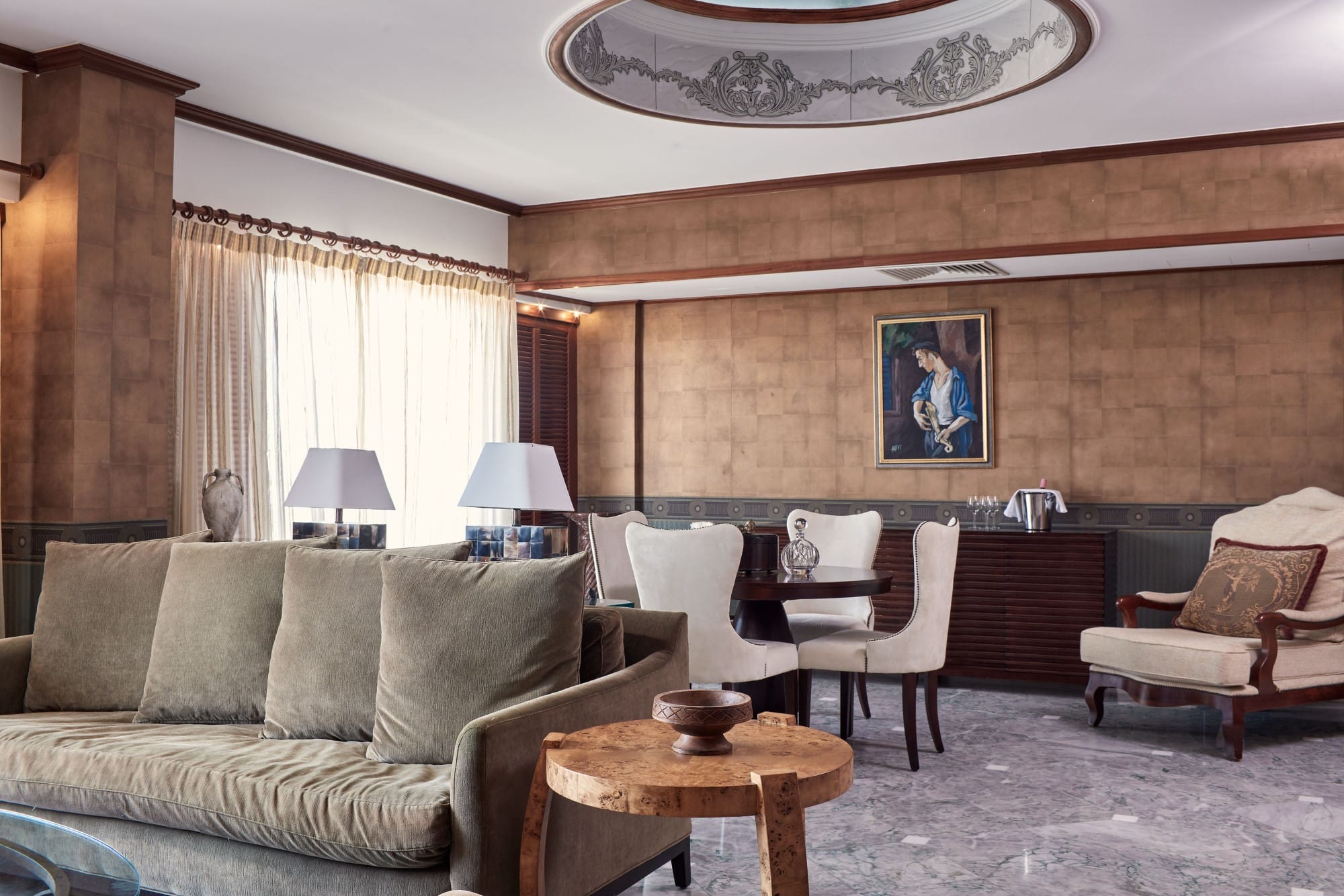 a living room with a couch and chairs