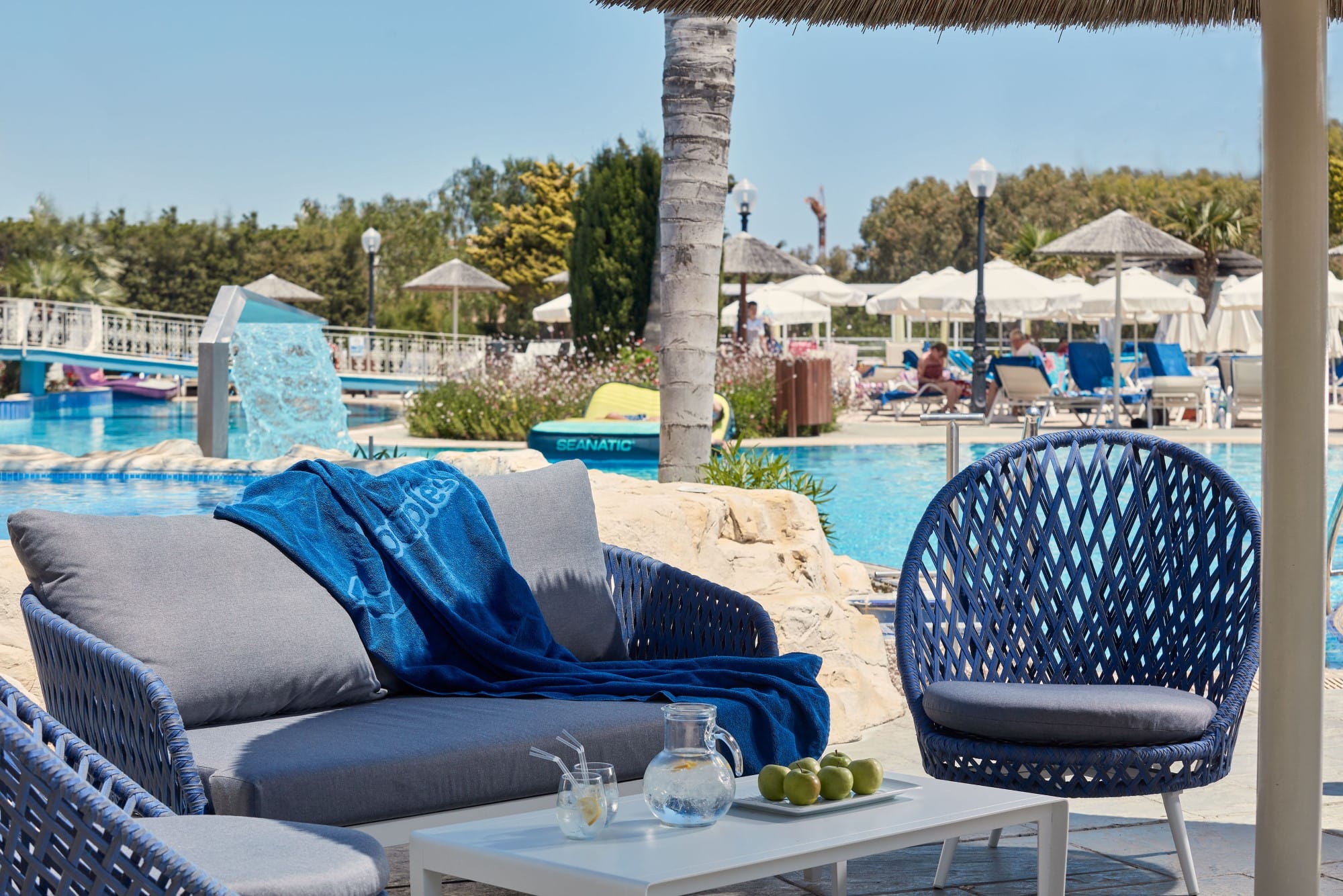 a pool with chairs and umbrellas