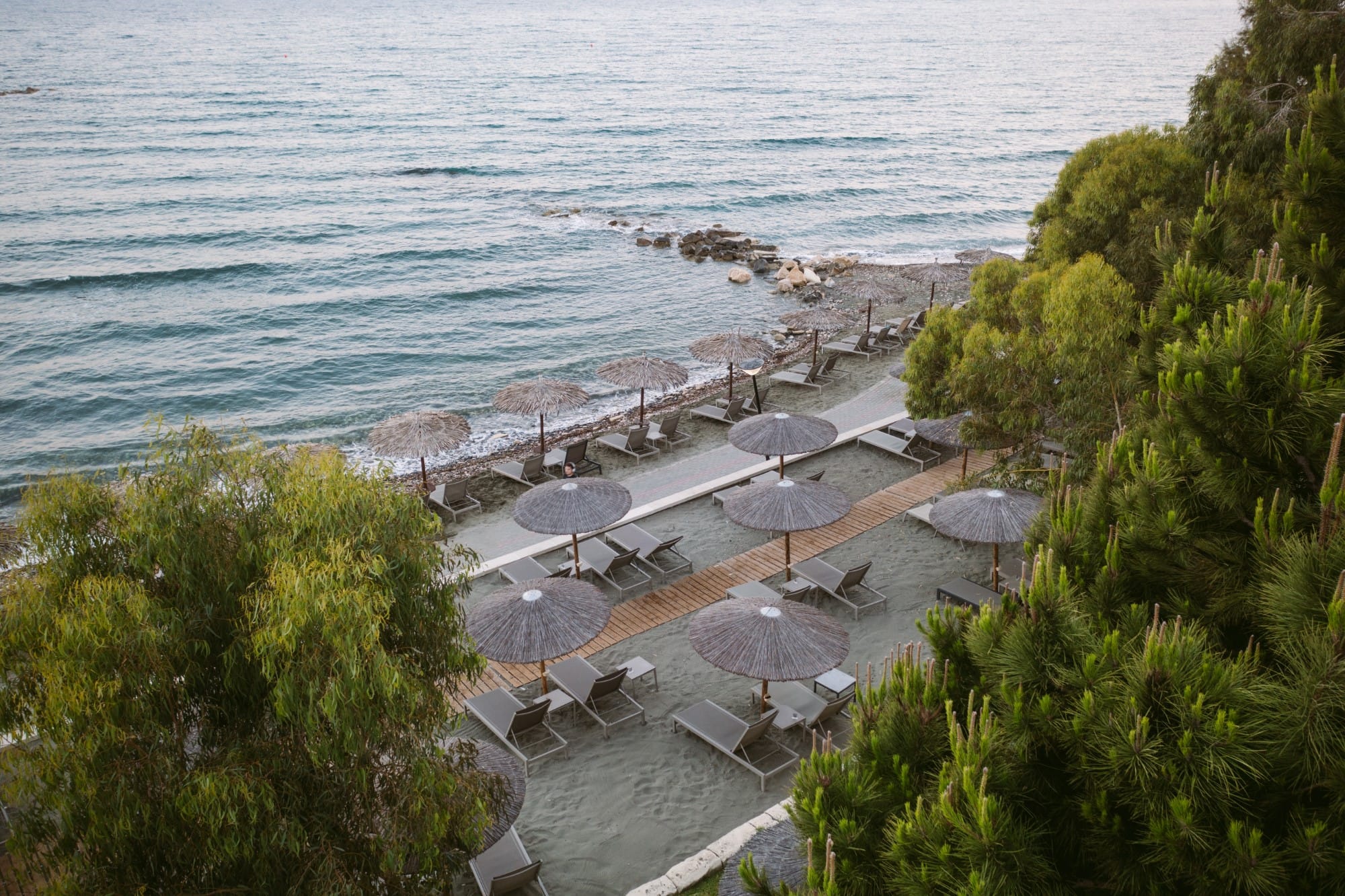 a beach with umbrellas and chairs
