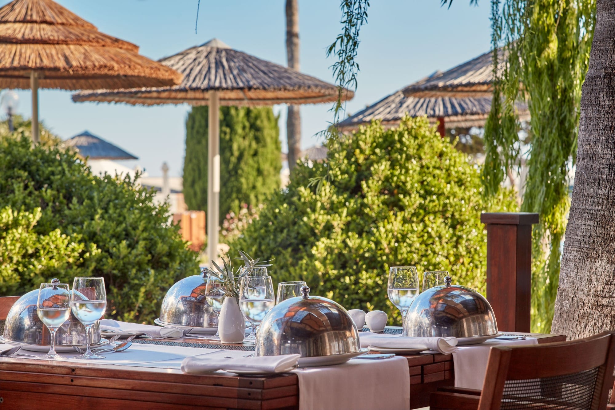 a table with glasses and umbrellas