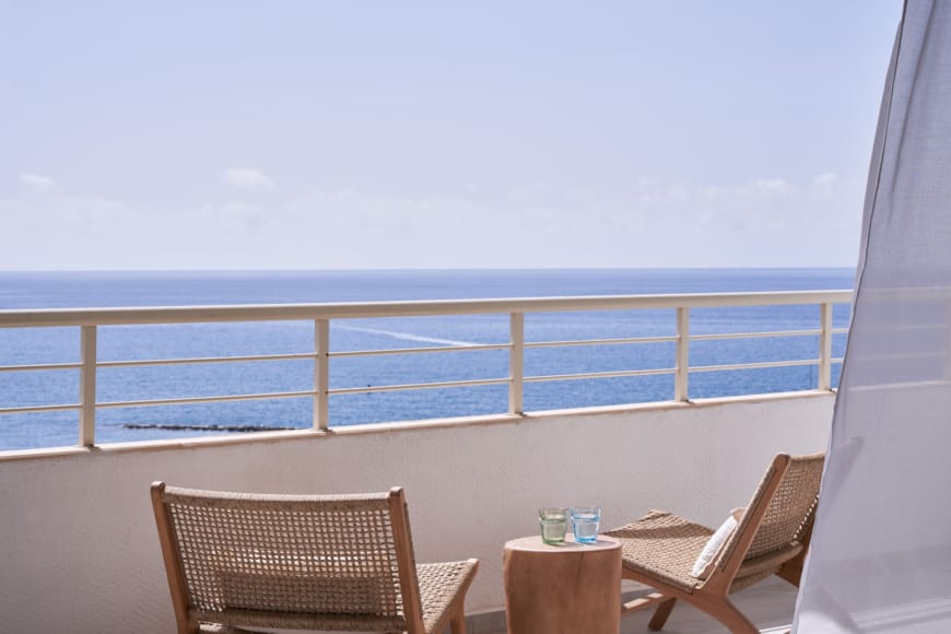 a table and chairs on a balcony