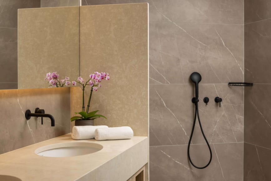 a bathroom with a sink and a plant in it