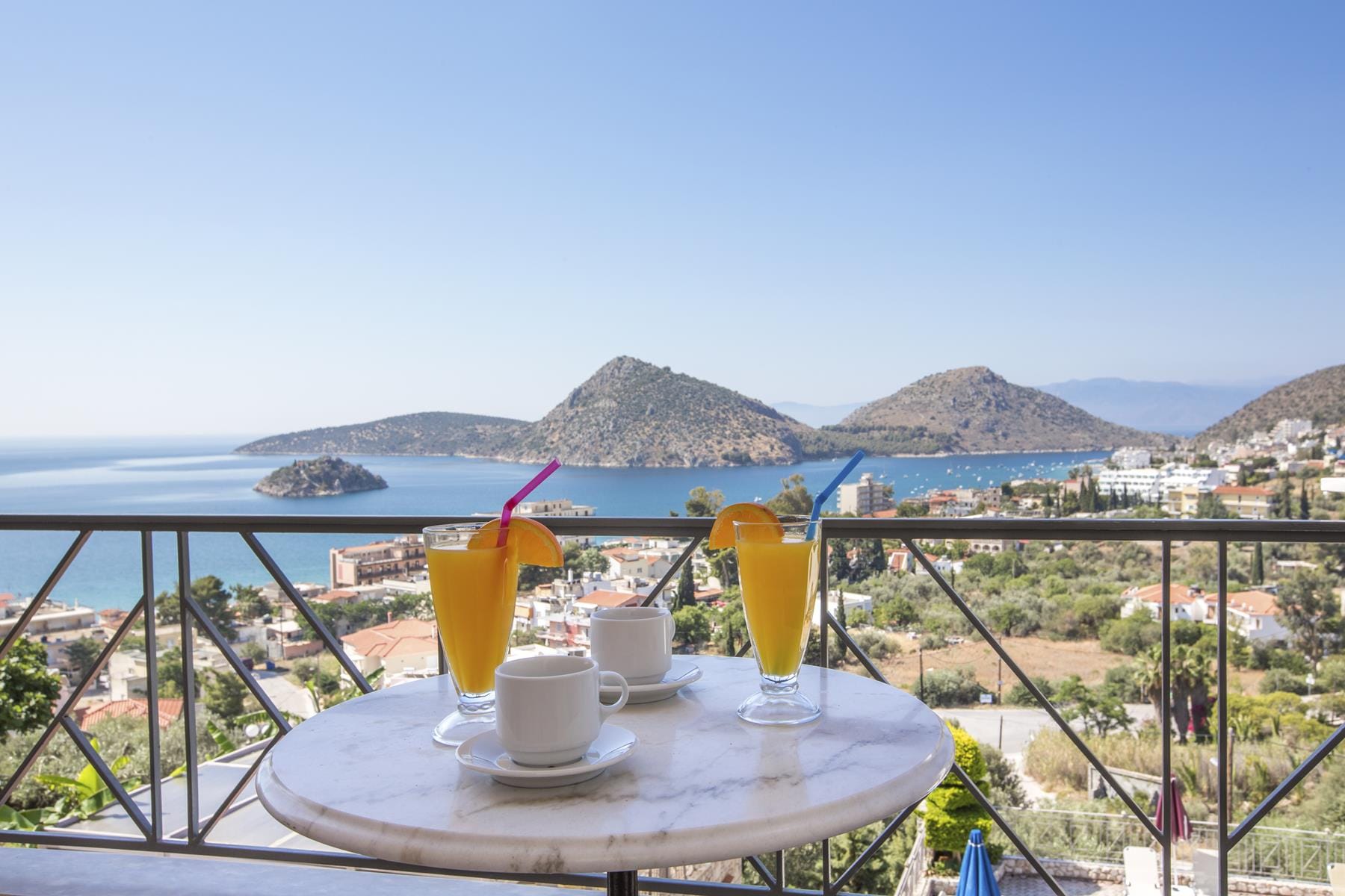 a table with drinks on it by a body of water