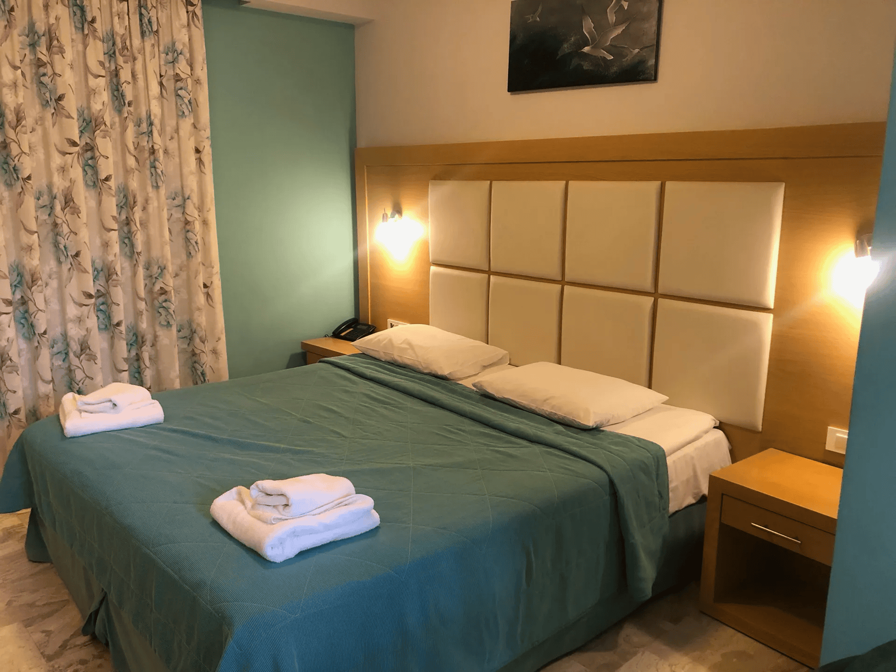 a hotel room with a bed and a lamp