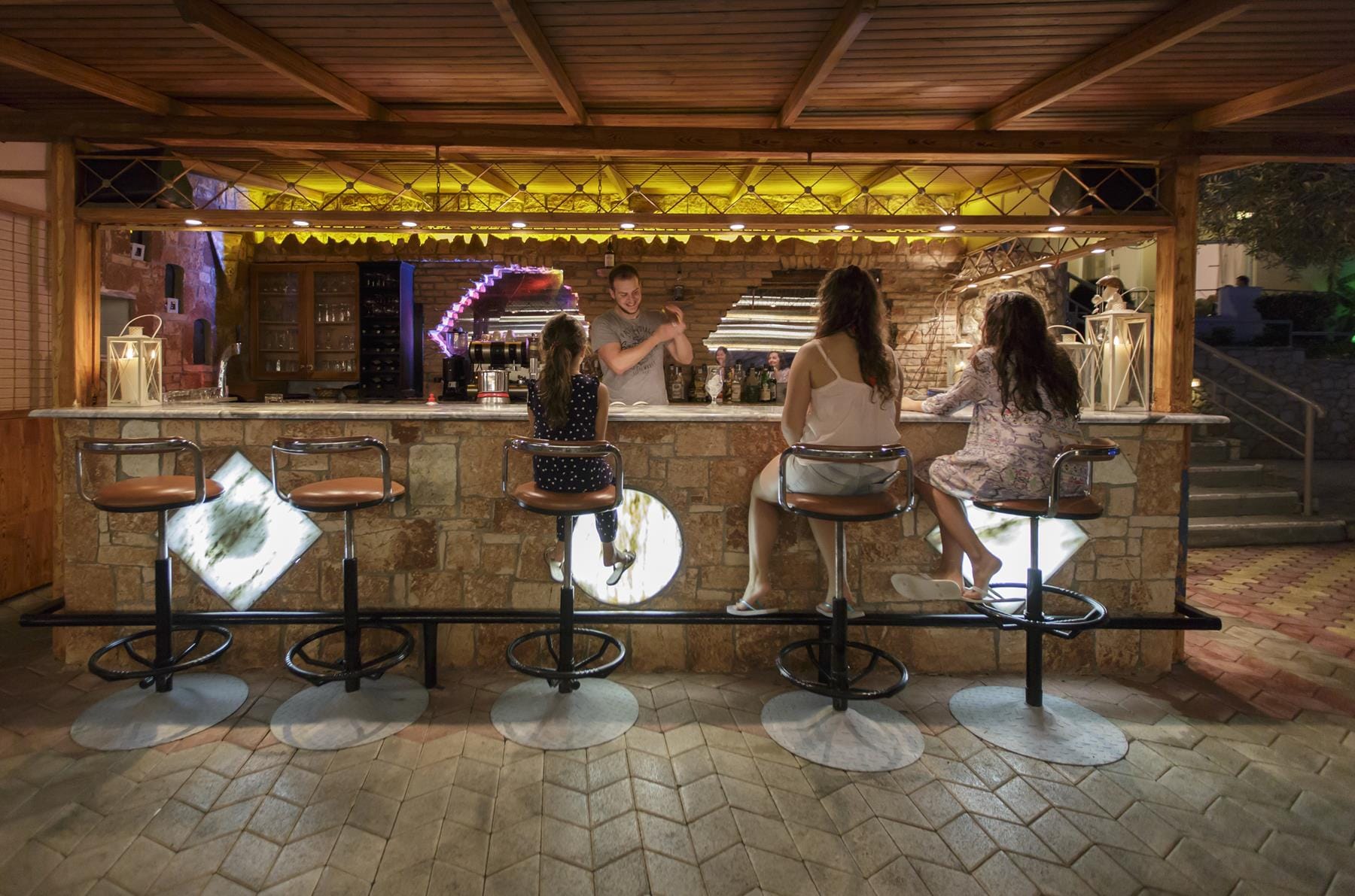 a group of people sitting at a bar