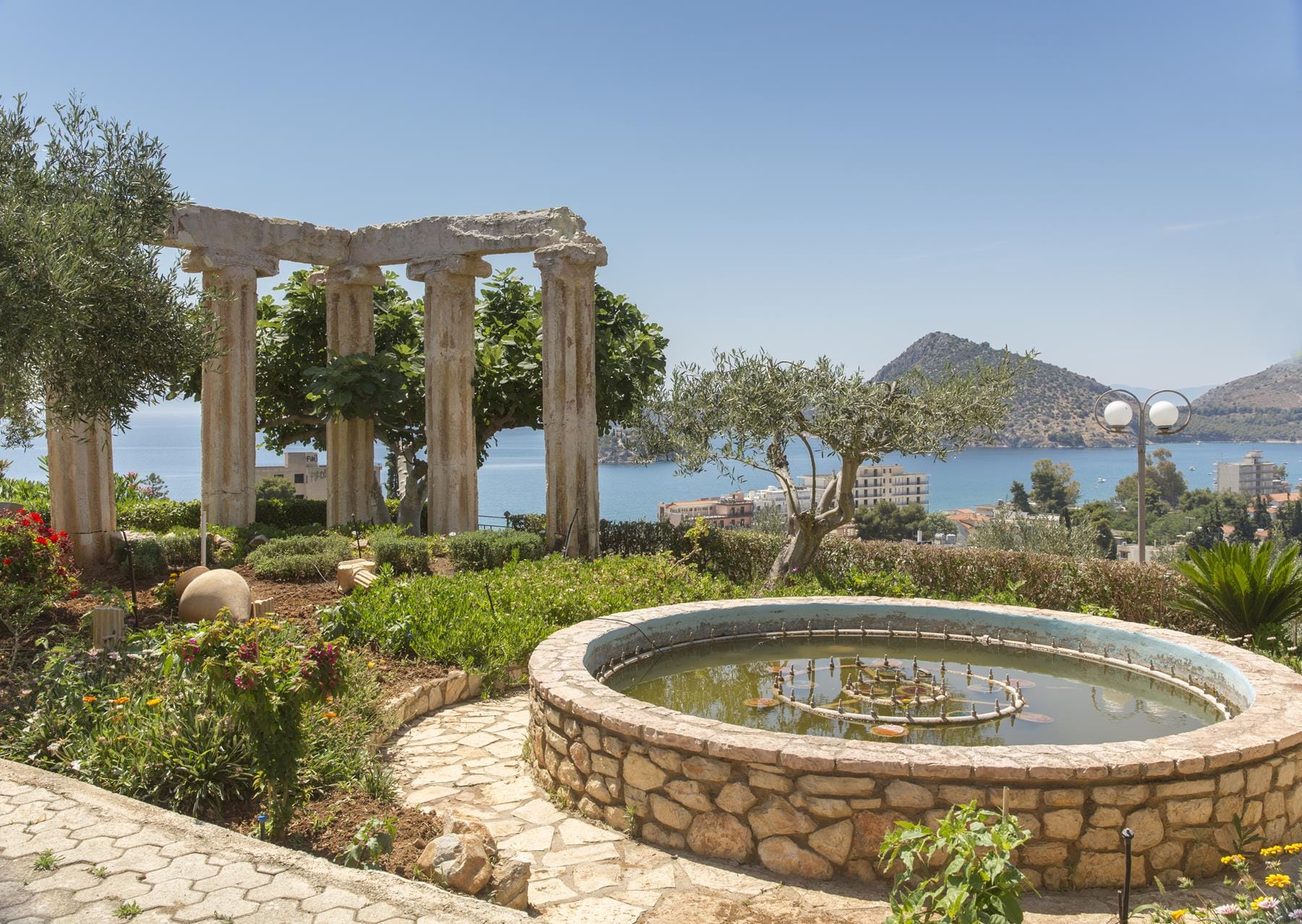a circular fountain in a garden