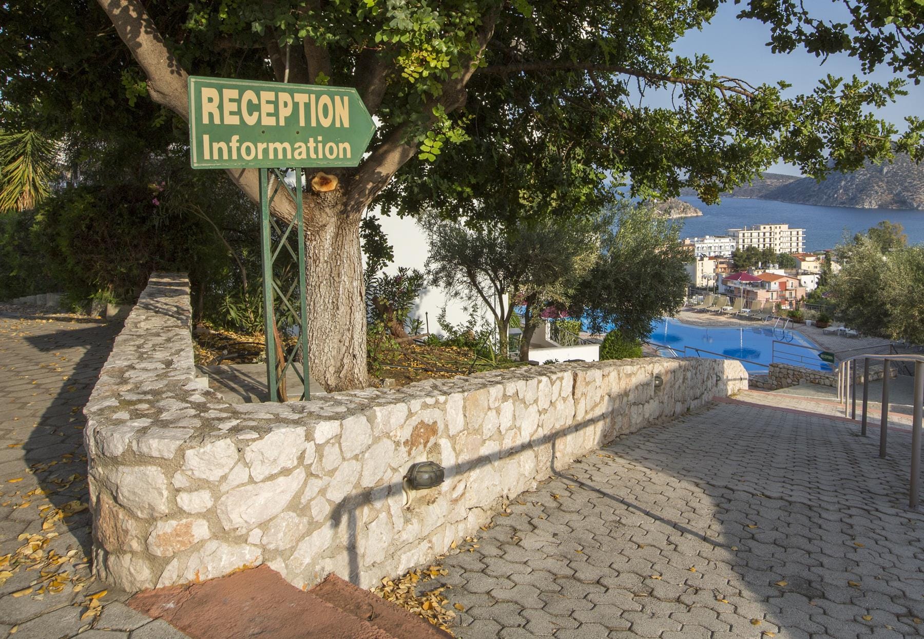 a sign on a stone wall