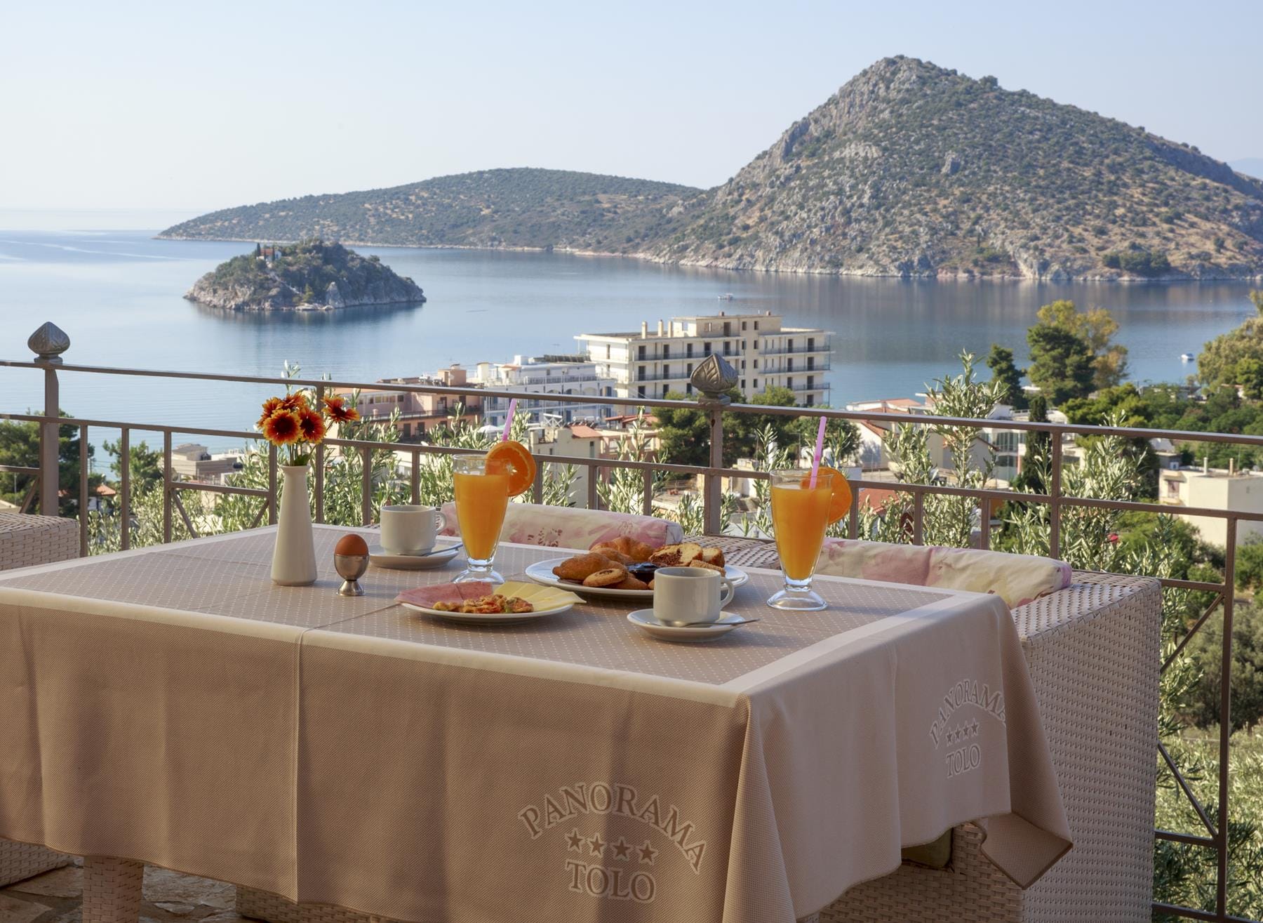 a table with food and drinks on it by a body of water