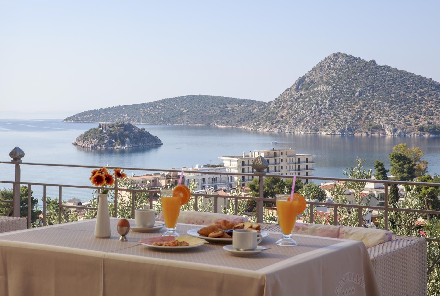 a table with food and drinks on it by a body of water