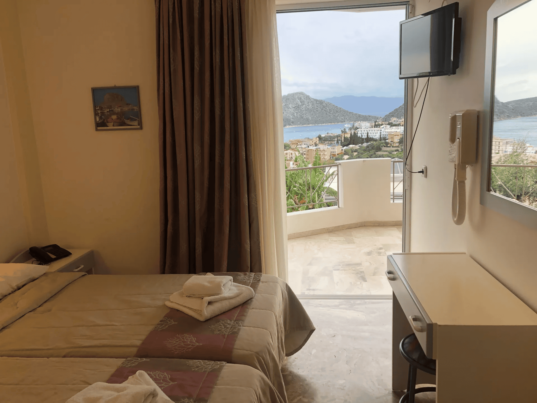 a bedroom with a view of the city