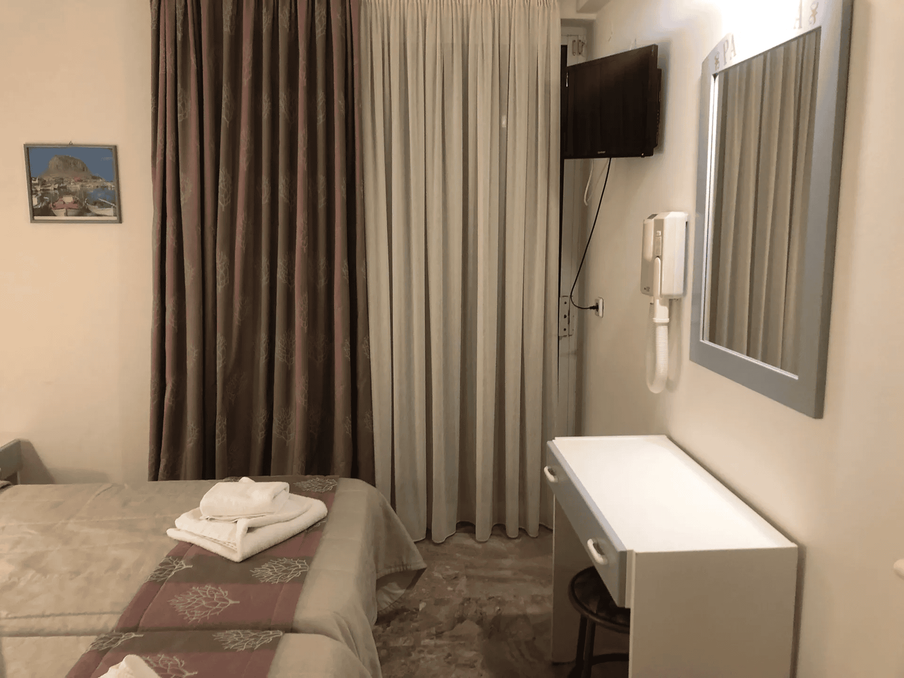 a bedroom with a tv and a bed