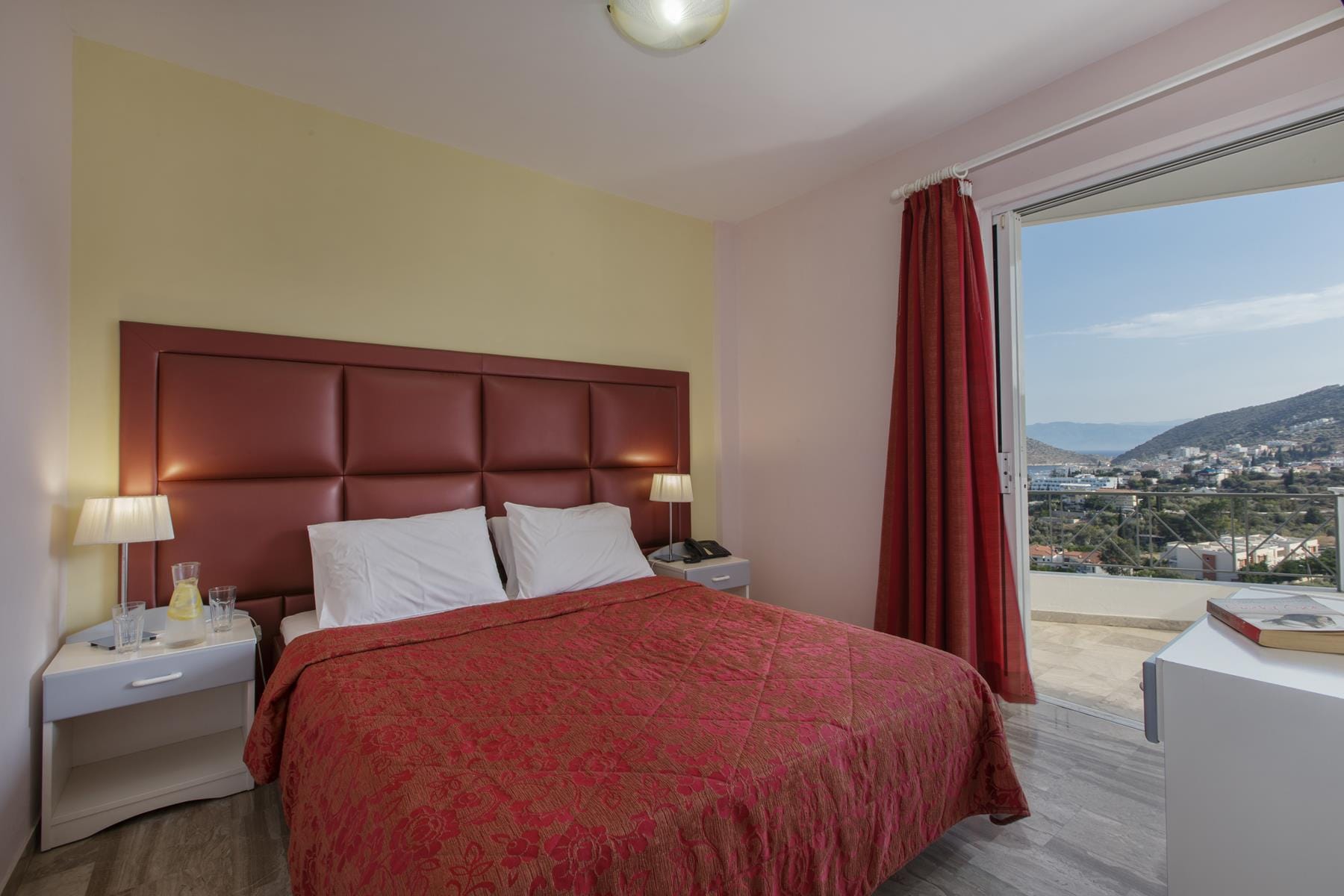 a bedroom with a red bed