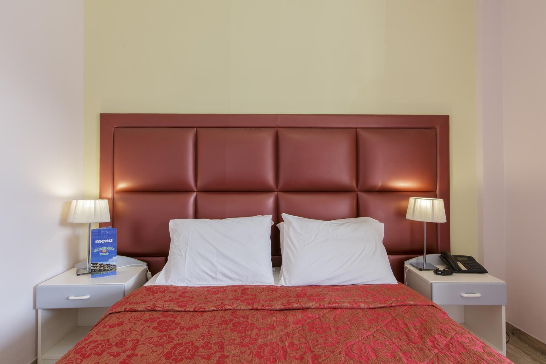 a bed with a red comforter