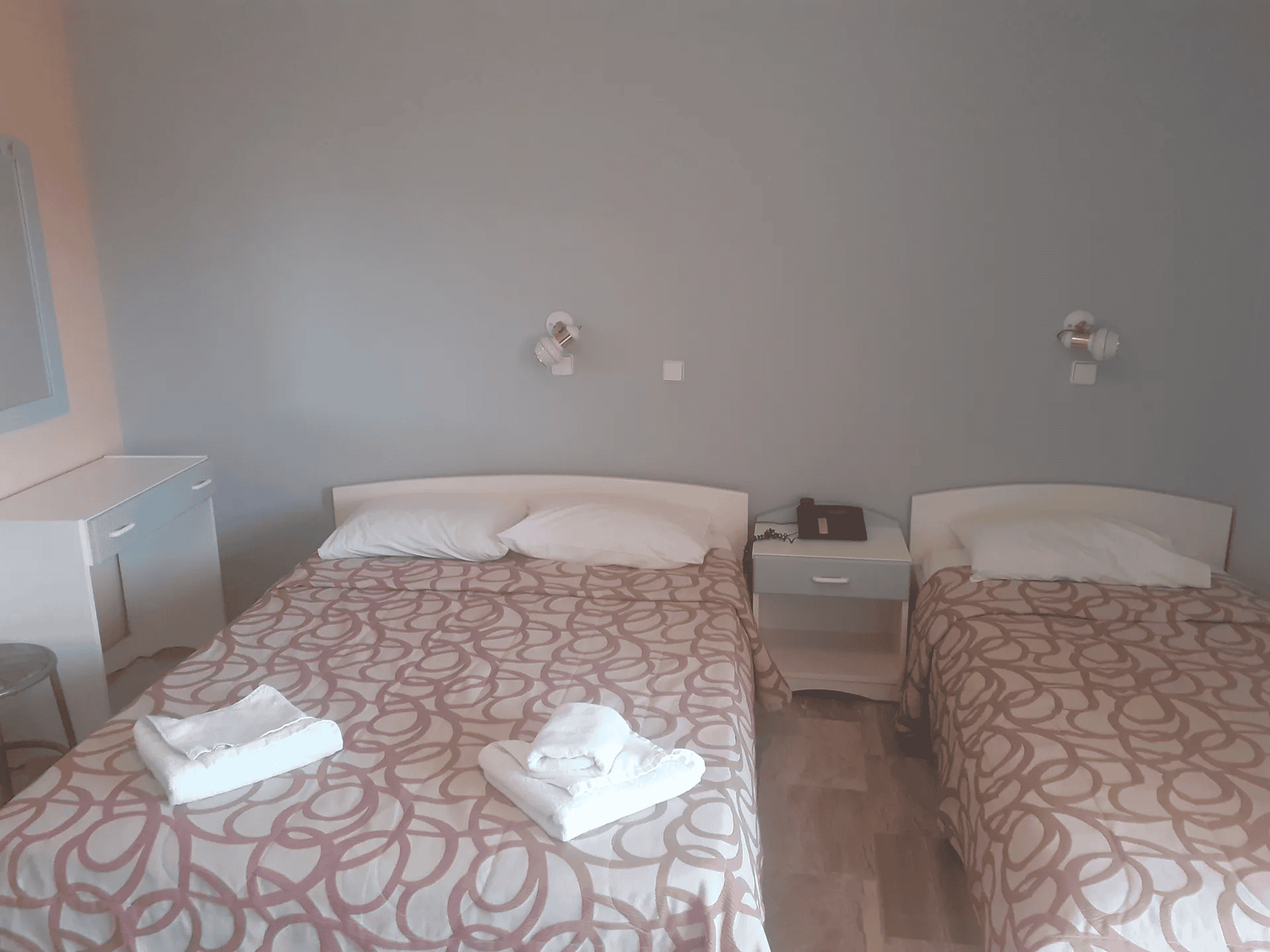 a couple of beds in a room