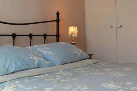 a bed with a blue and white comforter