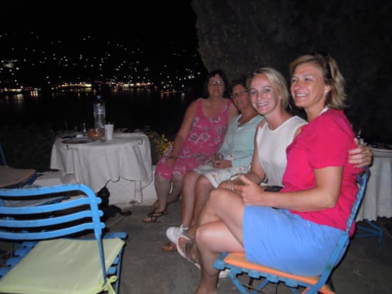 a group of women sitting on chairs at a table