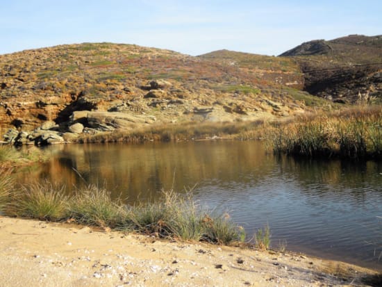 a body of water with hills in the background