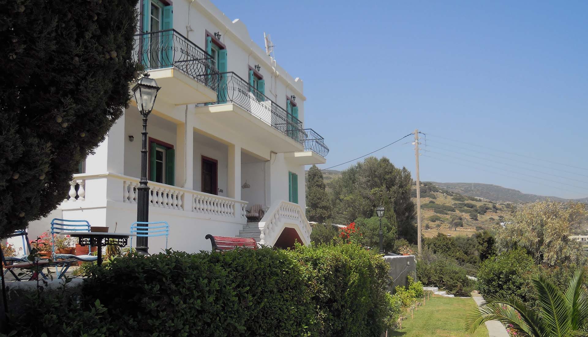a white building with a green roof